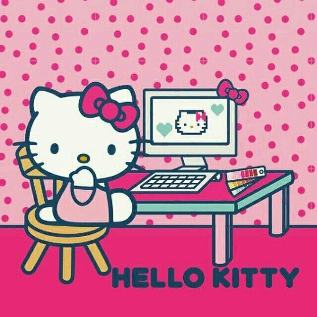 hello kitty sitting near a computer